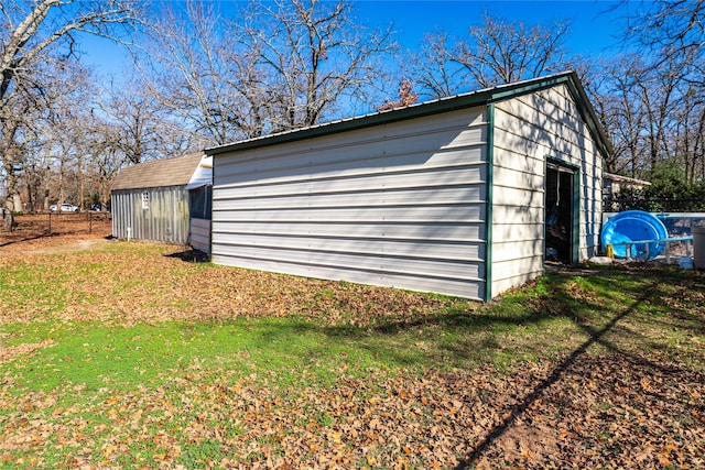 view of outbuilding featuring a yard