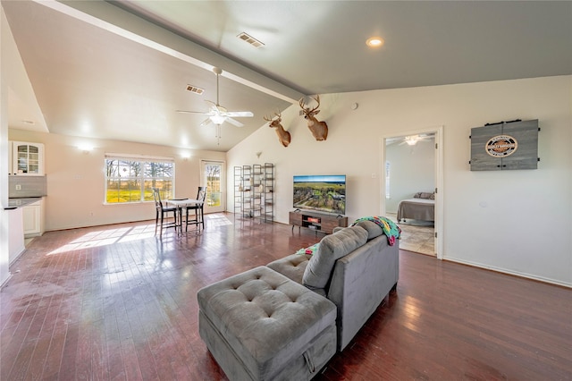 living room featuring vaulted ceiling with beams, ceiling fan, and dark wood-type flooring