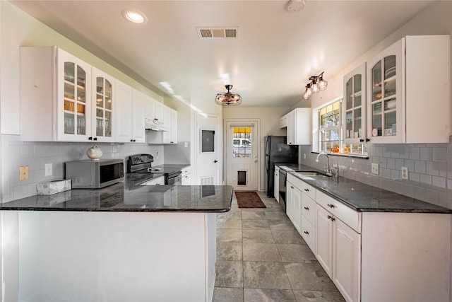 kitchen with white cabinetry, kitchen peninsula, sink, and black appliances