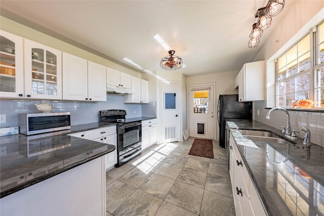 kitchen with white cabinetry, sink, dark stone countertops, backsplash, and black appliances