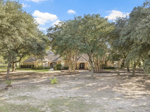 view of property hidden behind natural elements