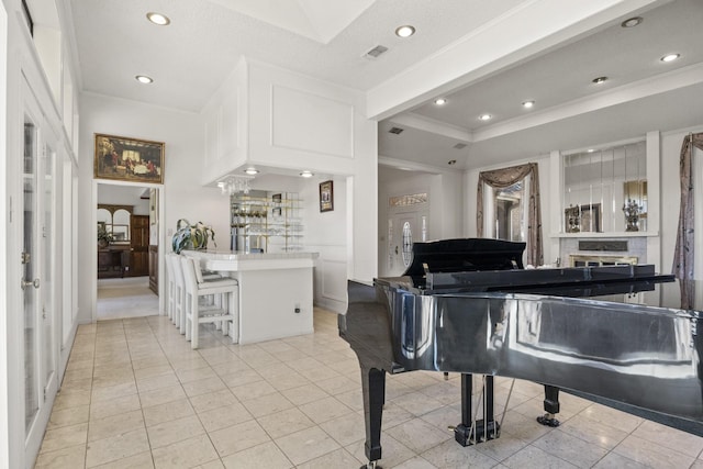 interior space featuring ornamental molding, light tile patterned floors, and a tray ceiling