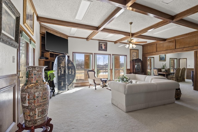 carpeted living room featuring beamed ceiling, ceiling fan, coffered ceiling, and a textured ceiling