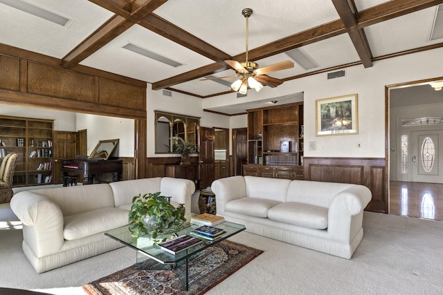 living room featuring beamed ceiling, coffered ceiling, light carpet, and ceiling fan