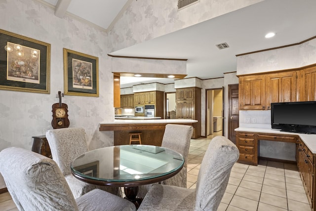 tiled dining area featuring ornamental molding and high vaulted ceiling