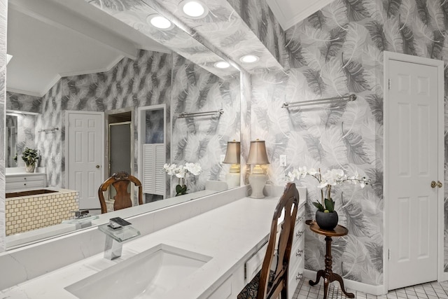 bathroom with ornamental molding, tile patterned flooring, vaulted ceiling, and vanity