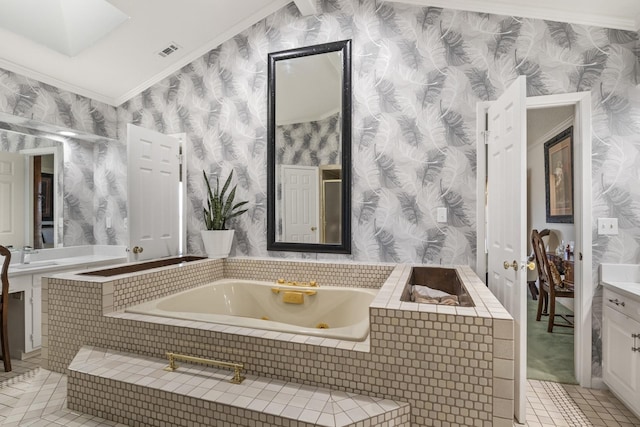 bathroom with crown molding, tile patterned floors, tiled bath, and sink