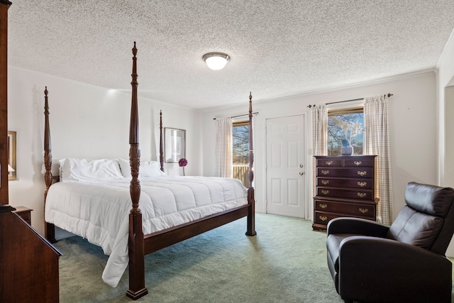 carpeted bedroom featuring ornamental molding and a textured ceiling