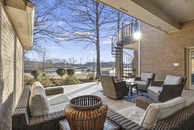 view of patio / terrace with a water view and an outdoor hangout area