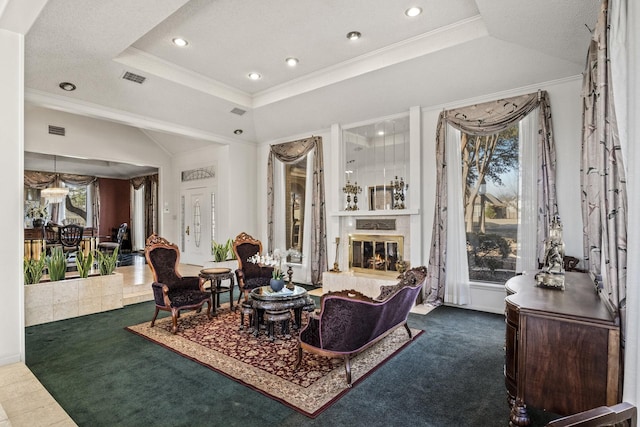 carpeted living room with ornamental molding and a raised ceiling