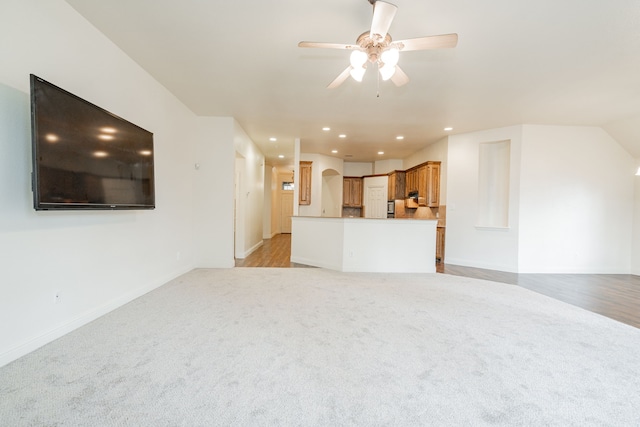 unfurnished living room with ceiling fan and light colored carpet