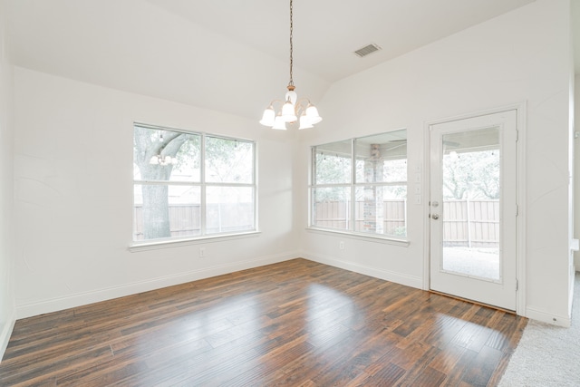 unfurnished dining area featuring an inviting chandelier, dark hardwood / wood-style flooring, lofted ceiling, and plenty of natural light