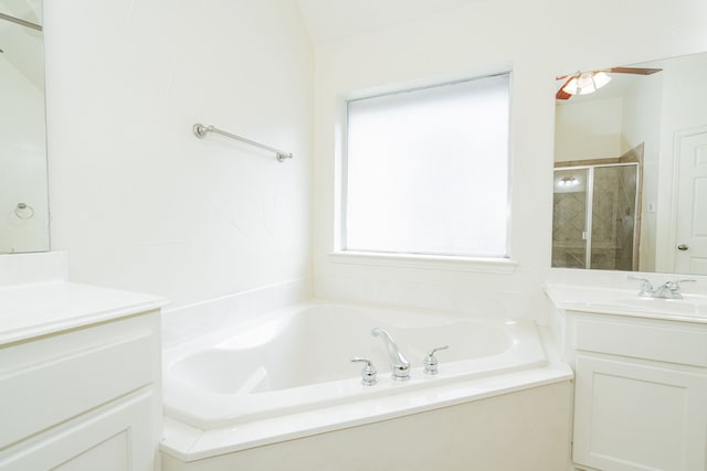 bathroom featuring shower with separate bathtub and vanity