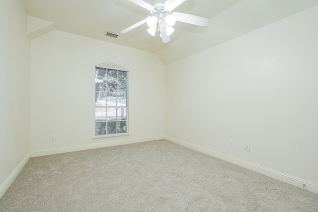 unfurnished room featuring ceiling fan, light colored carpet, and lofted ceiling