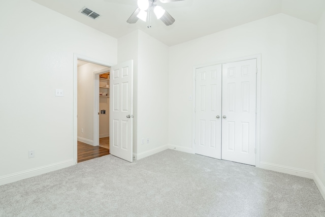 unfurnished bedroom featuring ceiling fan, a closet, and light carpet