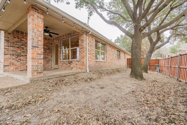 view of side of property featuring ceiling fan and a patio