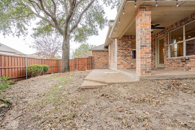 view of yard featuring ceiling fan and a patio area