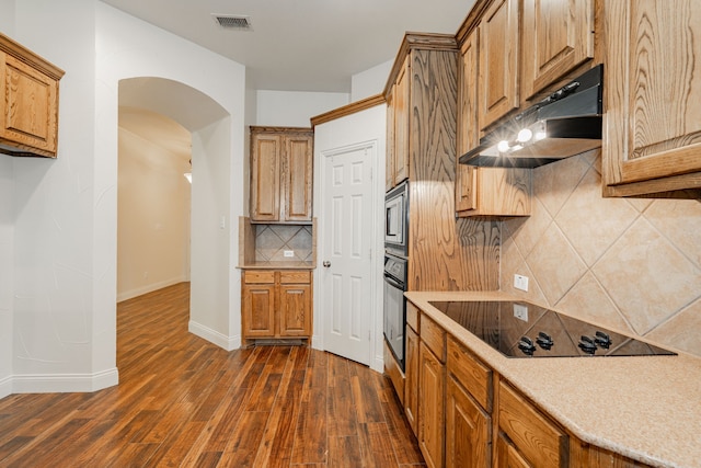 kitchen with decorative backsplash, dark wood-type flooring, and black appliances