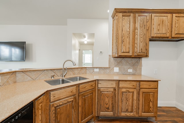 kitchen with backsplash, dishwasher, sink, and dark hardwood / wood-style flooring