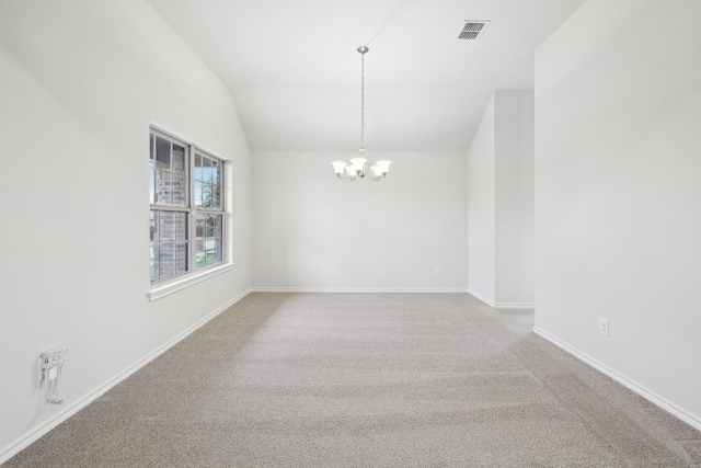 spare room featuring a notable chandelier, lofted ceiling, and carpet floors