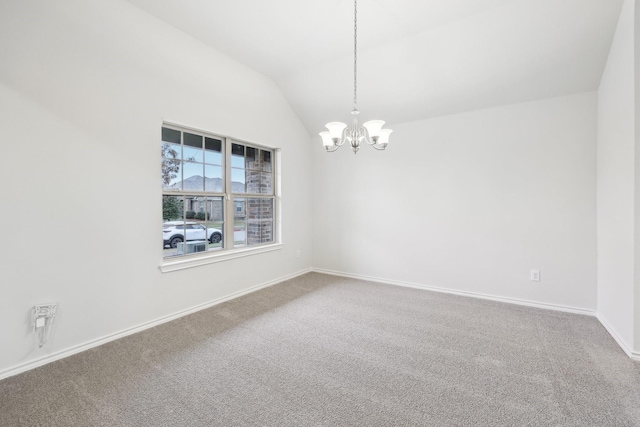 spare room featuring carpet, lofted ceiling, and an inviting chandelier