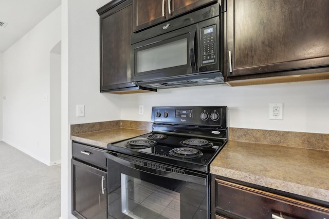 kitchen featuring dark brown cabinetry, light colored carpet, and black appliances