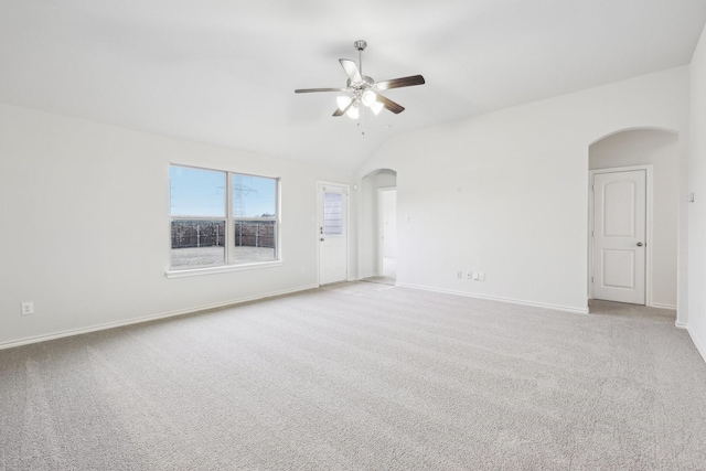 carpeted empty room with ceiling fan and vaulted ceiling