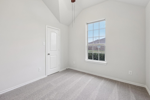 carpeted empty room featuring ceiling fan and vaulted ceiling