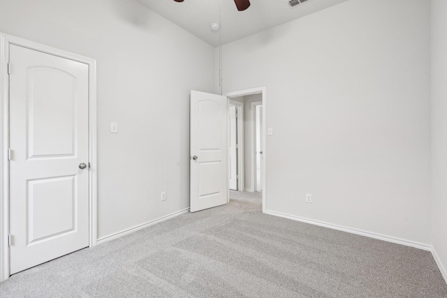 unfurnished room with light carpet, high vaulted ceiling, and ceiling fan