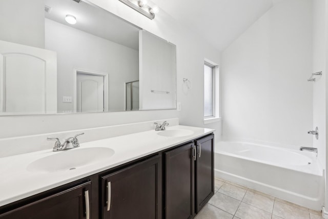 bathroom featuring plus walk in shower, tile patterned flooring, vanity, and vaulted ceiling