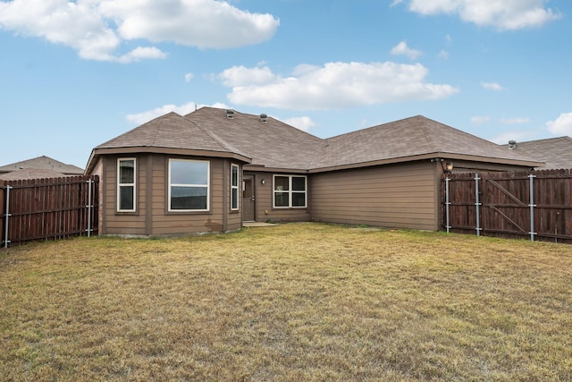 rear view of property with a yard