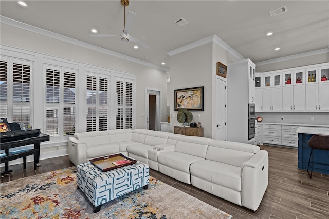 living room with ceiling fan and ornamental molding