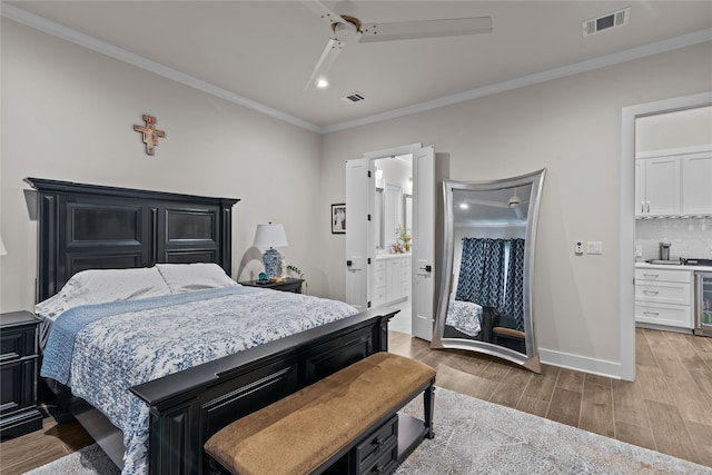 bedroom featuring connected bathroom, ceiling fan, beverage cooler, and ornamental molding