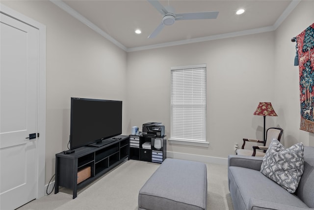 carpeted living room with ceiling fan and ornamental molding