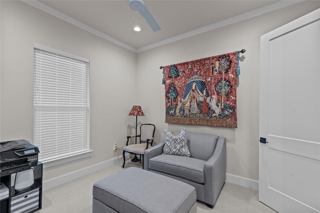 sitting room featuring crown molding and light carpet