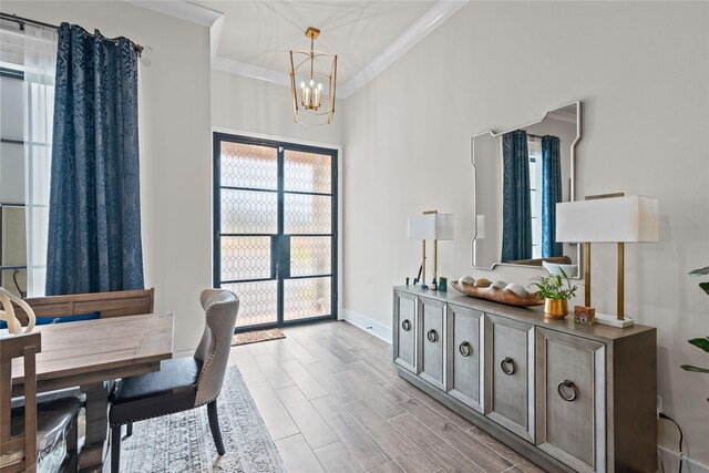 dining space featuring crown molding and a chandelier