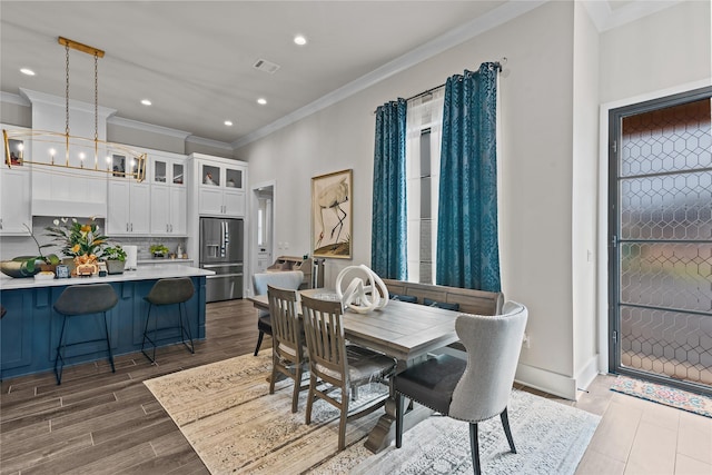 dining area with crown molding and an inviting chandelier