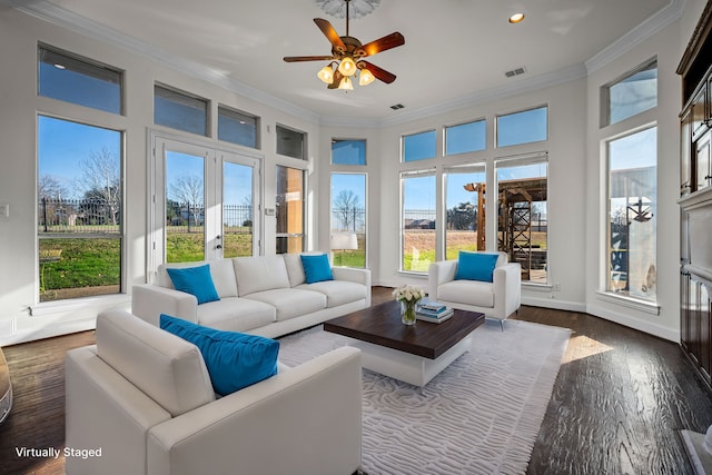 sunroom featuring a ceiling fan and visible vents