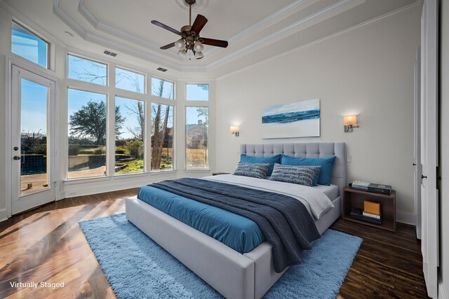 bedroom featuring visible vents, crown molding, access to exterior, wood finished floors, and a tray ceiling