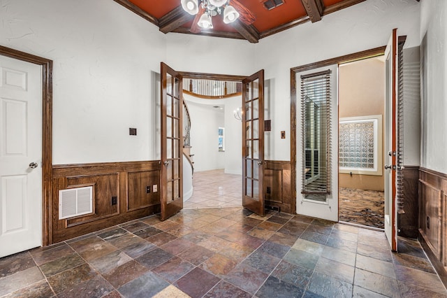 foyer featuring french doors, ceiling fan, coffered ceiling, and beamed ceiling