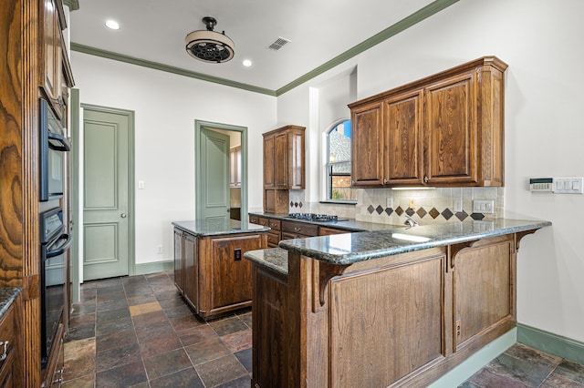 kitchen with a breakfast bar, tasteful backsplash, ornamental molding, a center island, and kitchen peninsula