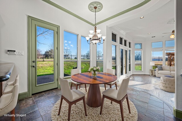 sunroom featuring stone tile flooring, crown molding, baseboards, a chandelier, and french doors