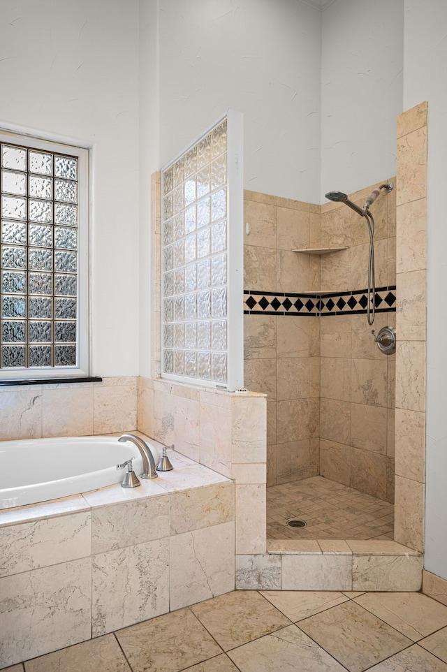 full bath featuring a bath and tiled shower