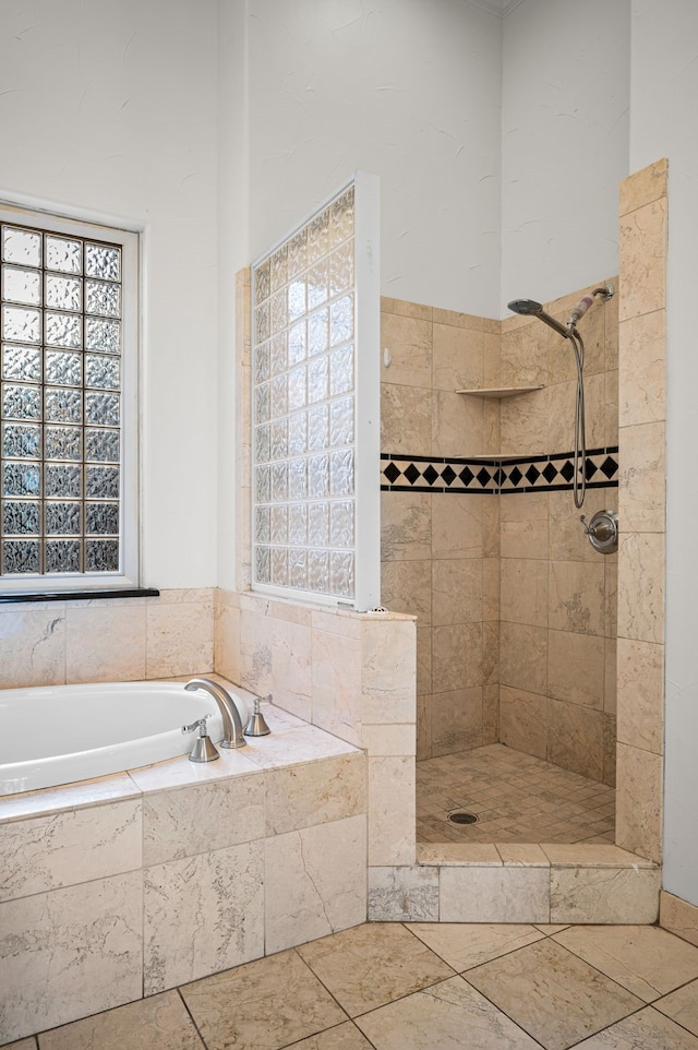 full bath with a tile shower and a garden tub