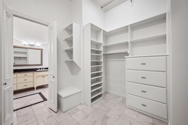 walk in closet featuring a sink