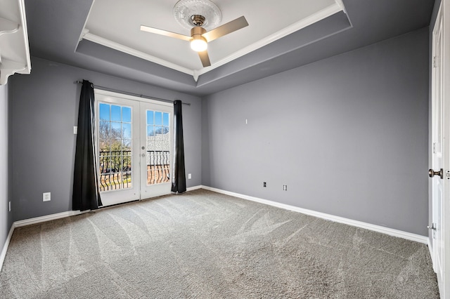 unfurnished room with french doors, ceiling fan, a raised ceiling, and carpet floors