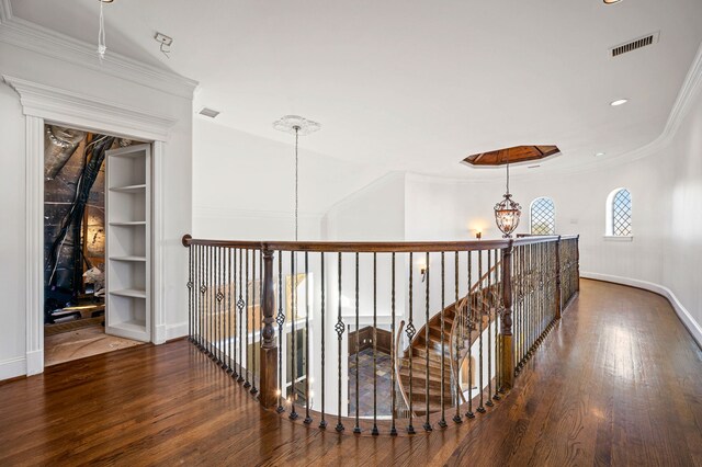 corridor with visible vents, baseboards, and wood finished floors
