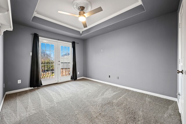 unfurnished room featuring carpet floors, baseboards, a raised ceiling, french doors, and a ceiling fan