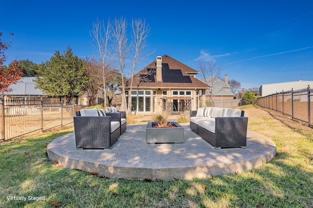 back of property featuring a patio area, a lawn, an outdoor living space with a fire pit, and a fenced backyard