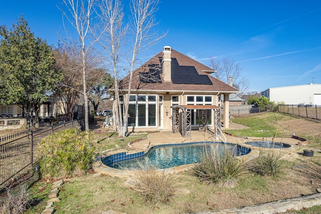 view of pool featuring an in ground hot tub, a fenced backyard, a fenced in pool, and a patio